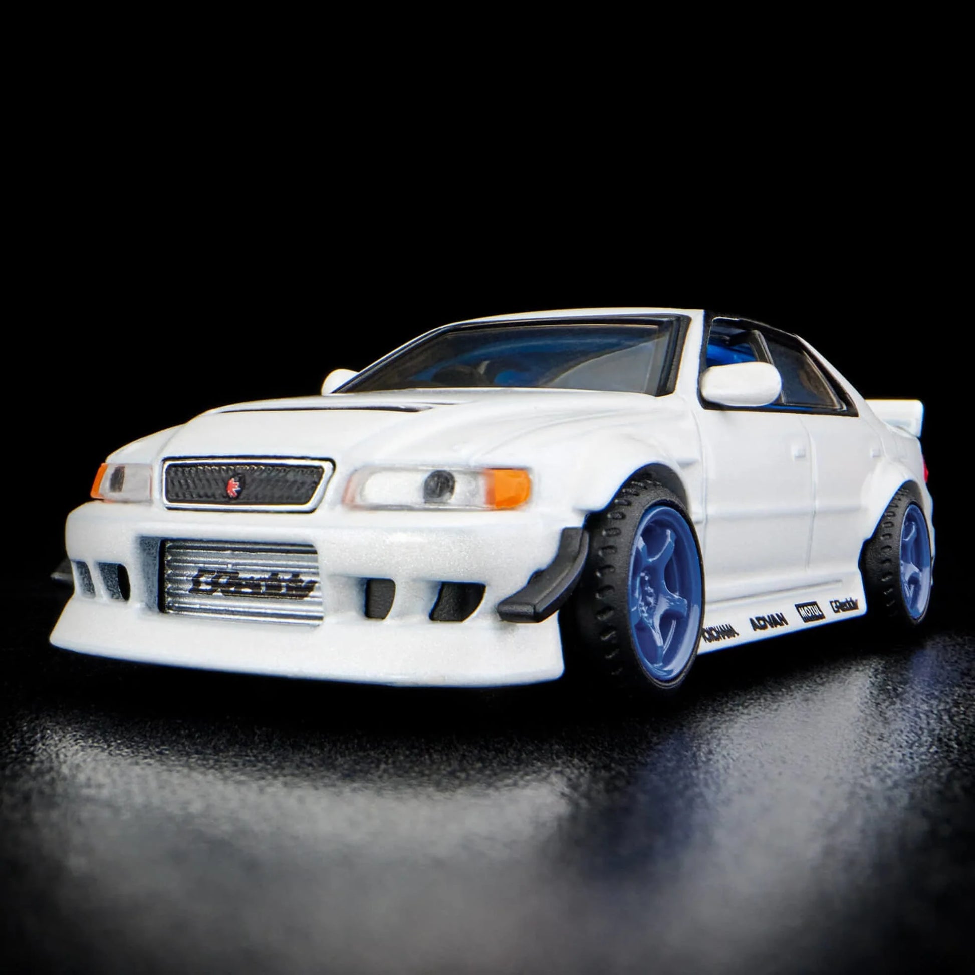 Hot Wheels 1:64 scale Elite 64 die-cast model of the 1996 Toyota Chaser JZX100 in pearlescent white with Real Riders wheels and drift-inspired detailing